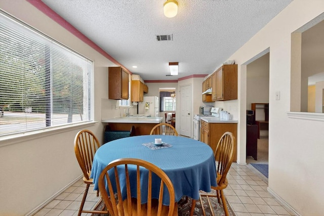 12062 Lincolnshire Dr, Austin, TX 78758 - dining space with light tile patterned flooring and a textured ceiling