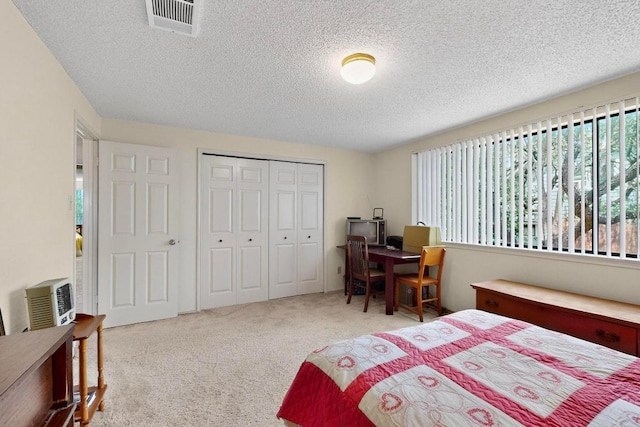 12062 Lincolnshire Dr, Austin, TX 78758 - bedroom featuring a textured ceiling, a closet, and carpet floors