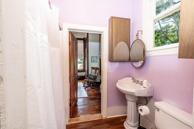 624 Saint Louis St, Gonzales, TX 78629 - bathroom with wood finished floors and curtained shower