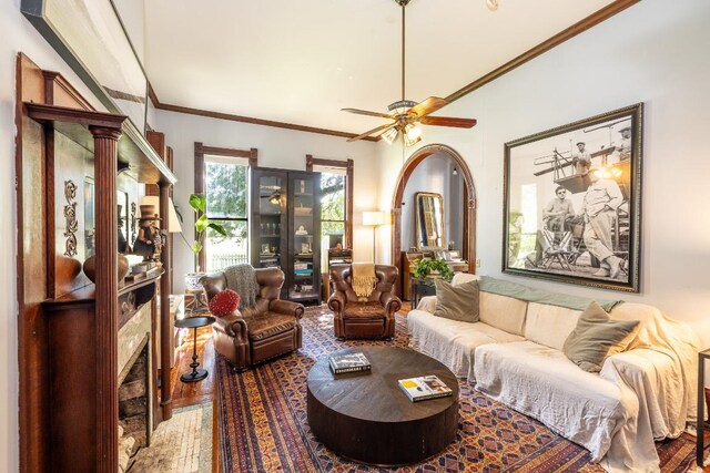 624 Saint Louis St, Gonzales, TX 78629 - living area featuring a premium fireplace, ceiling fan, wood finished floors, and ornamental molding