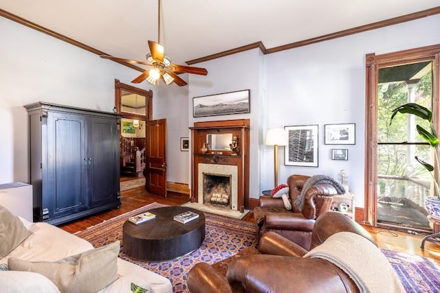 624 Saint Louis St, Gonzales, TX 78629 - living room with crown molding, a ceiling fan, wood finished floors, and a fireplace