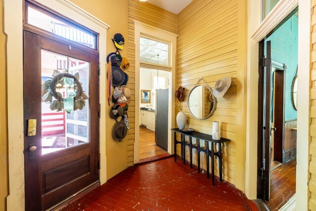 624 Saint Louis St, Gonzales, TX 78629 - foyer featuring wood-type flooring, plenty of natural light, and wood walls