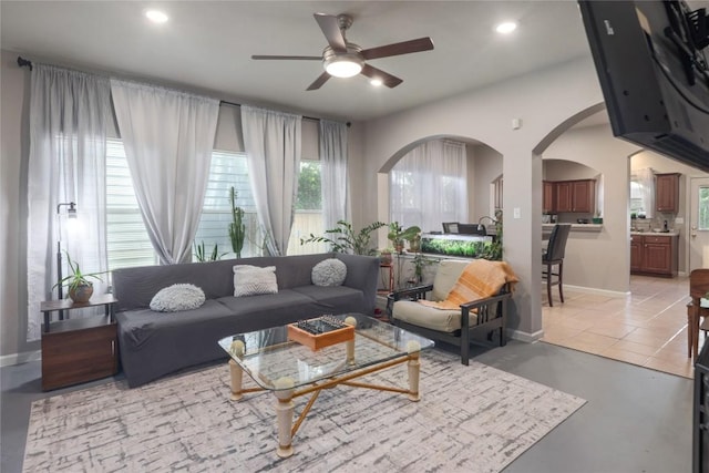 9213 Brents Elm Dr, Austin, TX 78744 - living area featuring arched walkways, a ceiling fan, recessed lighting, and concrete flooring