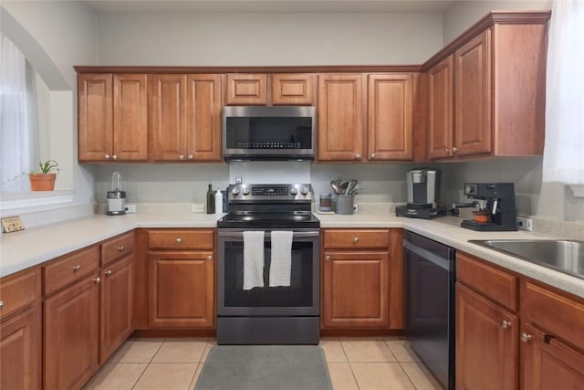9213 Brents Elm Dr, Austin, TX 78744 - kitchen with stainless steel appliances and brown cabinets