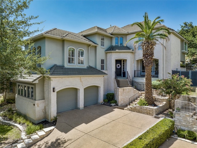 4332 Canoas Dr, Austin, TX 78730 - view of front of property with stucco siding, a garage, driveway, and a tile roof