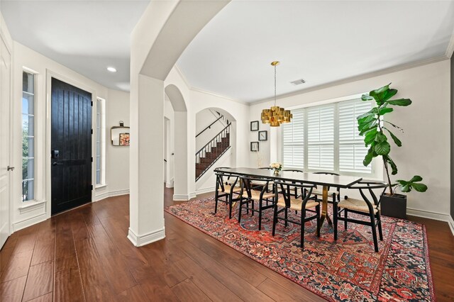 4332 Canoas Dr, Austin, TX 78730 - dining space featuring arched walkways, plenty of natural light, hardwood / wood-style flooring, stairs, and crown molding
