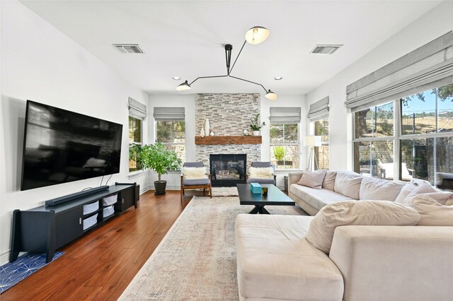 4332 Canoas Dr, Austin, TX 78730 - living room featuring dark wood-style floors, a stone fireplace, and recessed lighting