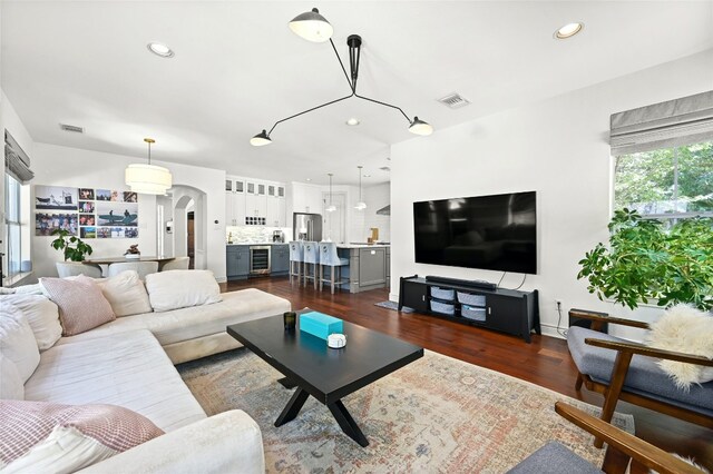 4332 Canoas Dr, Austin, TX 78730 - living room with arched walkways, dark wood-type flooring, recessed lighting, and wine cooler