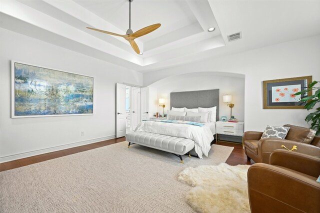 4332 Canoas Dr, Austin, TX 78730 - bedroom featuring a raised ceiling, wood finished floors, ceiling fan, recessed lighting, and arched walkways