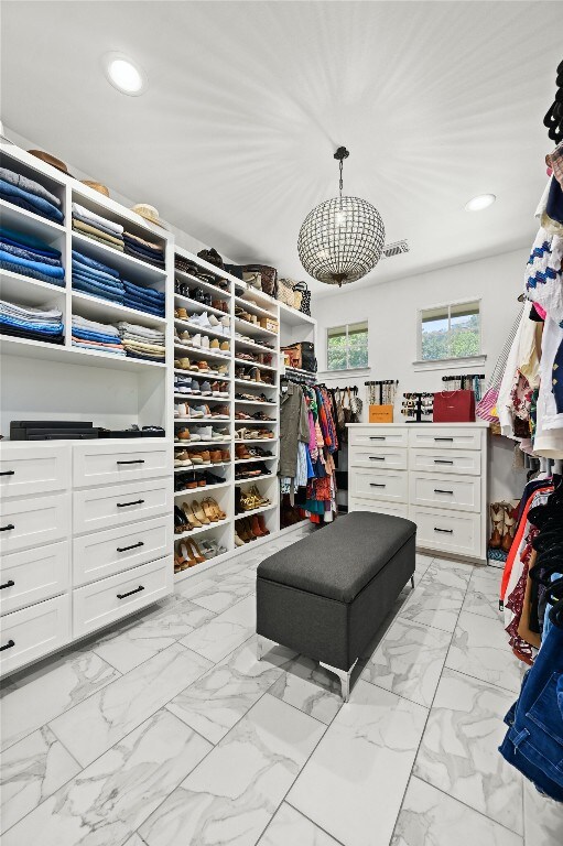 4332 Canoas Dr, Austin, TX 78730 - walk in closet with light marble finish flooring and a chandelier