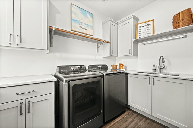 4332 Canoas Dr, Austin, TX 78730 - washroom with washer and dryer, cabinet space, and dark wood finished floors