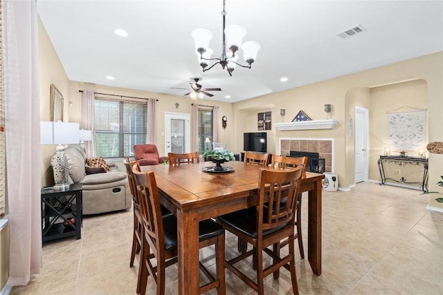 600 Gina Dr, Kyle, TX 78640 - dining space featuring a chandelier, a fireplace, light tile patterned flooring, a ceiling fan, and recessed lighting