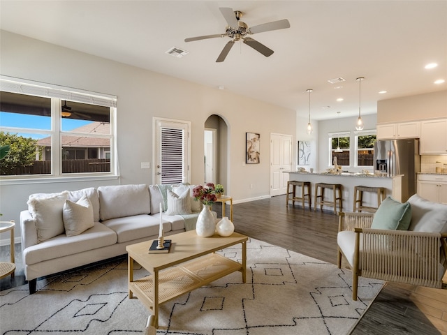 7816 Vista Mejor Dr, Austin, TX 78744 - living room featuring light wood-style flooring, a ceiling fan, recessed lighting, and arched walkways