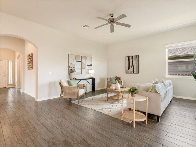 7816 Vista Mejor Dr, Austin, TX 78744 - living area with arched walkways, a ceiling fan, and wood finished floors