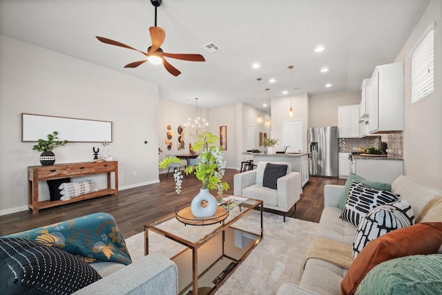 2205 Bonavista Way, Leander, TX 78641 - living area featuring dark wood finished floors, a ceiling fan, a chandelier, and recessed lighting