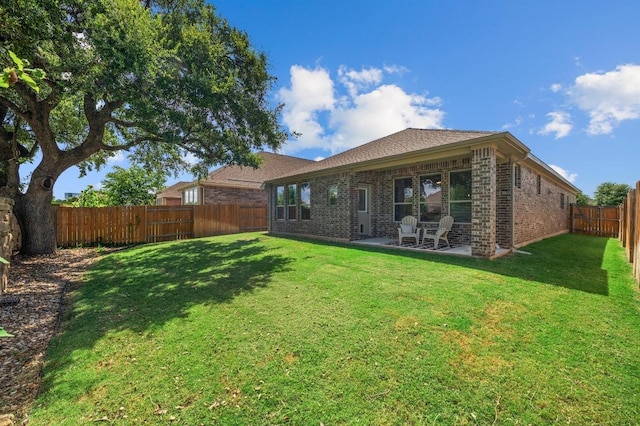 2205 Bonavista Way, Leander, TX 78641 - rear view of house with a fenced backyard, brick siding, and a patio area