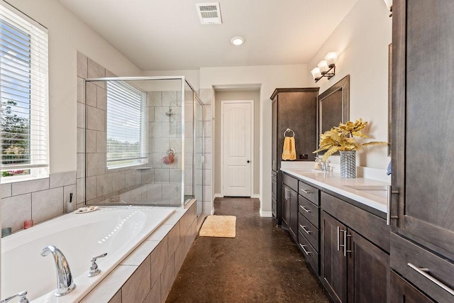 8054 Stone Mountain Trl, San Marcos, TX 78666 - bathroom featuring a garden tub, a stall shower, double vanity, and concrete floors