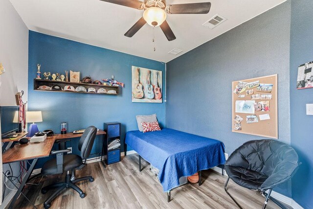 8054 Stone Mountain Trl, San Marcos, TX 78666 - bedroom featuring wood finished floors, a desk, and a ceiling fan