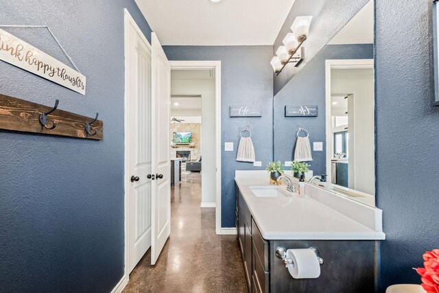 8054 Stone Mountain Trl, San Marcos, TX 78666 - bathroom with vanity, finished concrete flooring, and a textured wall