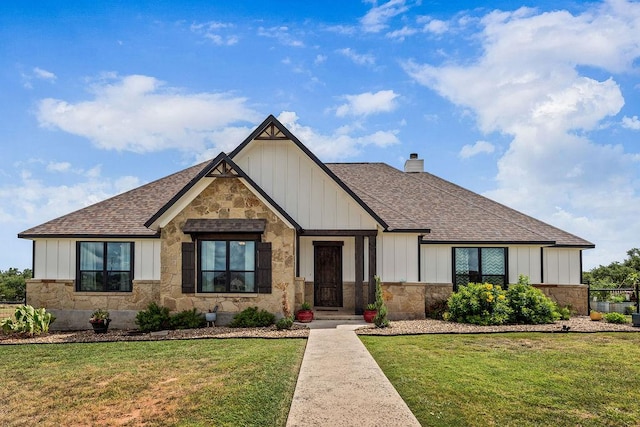 8054 Stone Mountain Trl, San Marcos, TX 78666 - view of front of house featuring board and batten siding, roof with shingles, stone siding, and a front yard