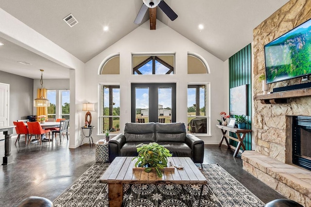 8054 Stone Mountain Trl, San Marcos, TX 78666 - living area featuring a fireplace, plenty of natural light, a ceiling fan, beamed ceiling, and high vaulted ceiling