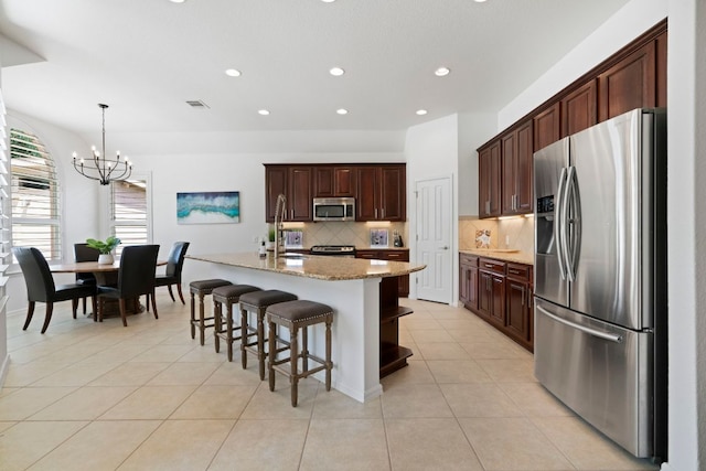 207 Dry Creek Rd, Austin, TX 78737 - kitchen featuring stainless steel appliances, a chandelier, backsplash, recessed lighting, and light tile patterned floors
