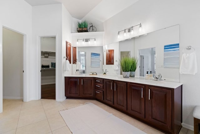 207 Dry Creek Rd, Austin, TX 78737 - full bathroom with double vanity, tile patterned flooring, a spacious closet, and high vaulted ceiling