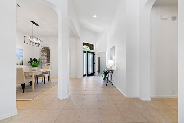 207 Dry Creek Rd, Austin, TX 78737 - foyer with arched walkways, light tile patterned floors, a chandelier, a towering ceiling, and recessed lighting