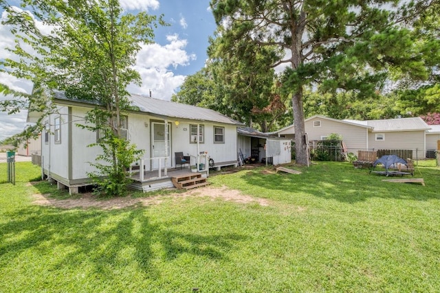 105 San Jacinto St, Smithville, TX 78957 - back of property with a deck and a metal roof