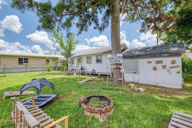 105 San Jacinto St, Smithville, TX 78957 - back of property with a fire pit and a metal roof