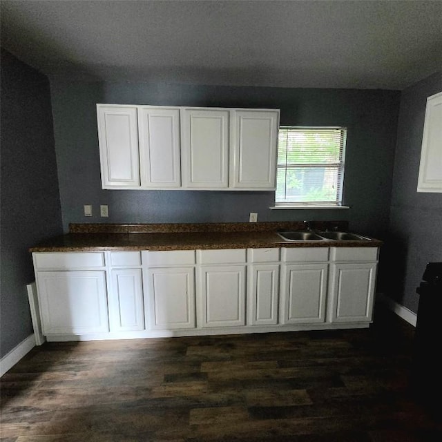 1403 S Salina St W, Austin, TX 78702 - kitchen featuring white cabinets, dark wood finished floors, and dark countertops