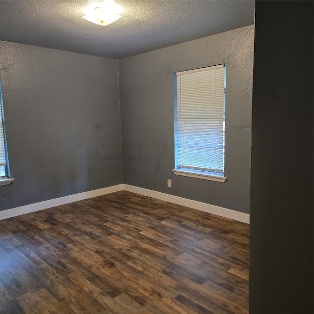 1403 S Salina St W, Austin, TX 78702 - empty room featuring dark wood-style floors and a textured ceiling