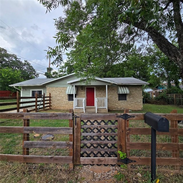 1403 S Salina St W, Austin, TX 78702 - view of front of property with a fenced front yard, a gate, and stone siding