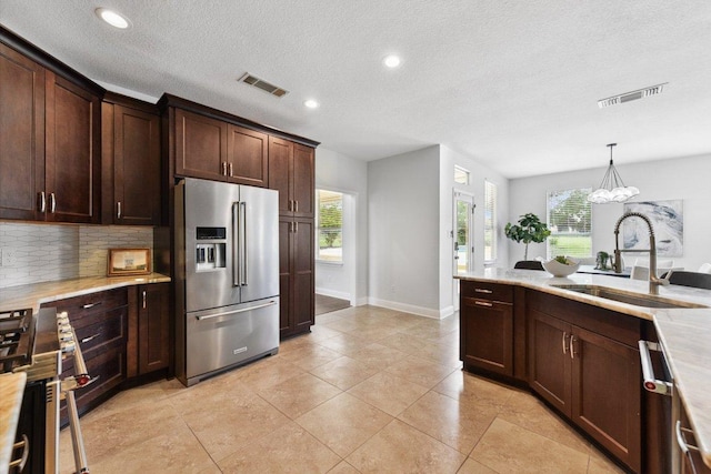 2009 Palos Verdes, Leander, TX 78641 - kitchen with appliances with stainless steel finishes, light countertops, backsplash, healthy amount of natural light, and recessed lighting