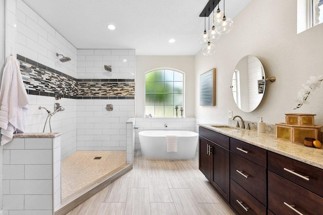 2009 Palos Verdes, Leander, TX 78641 - full bathroom with a walk in shower, vanity, a soaking tub, and recessed lighting