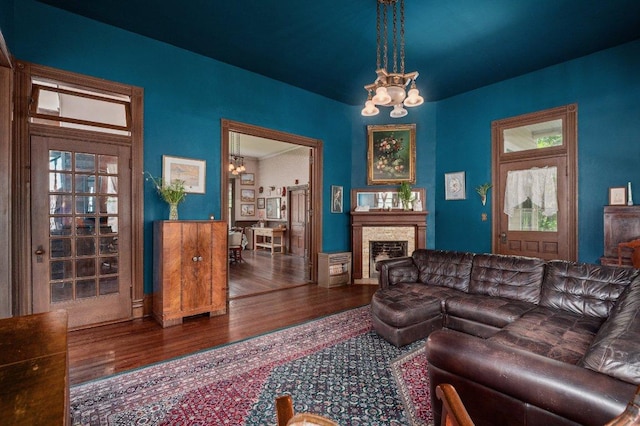124 N Hamilton St, Gonzales, TX 78629 - living room with a chandelier, wood finished floors, and a fireplace