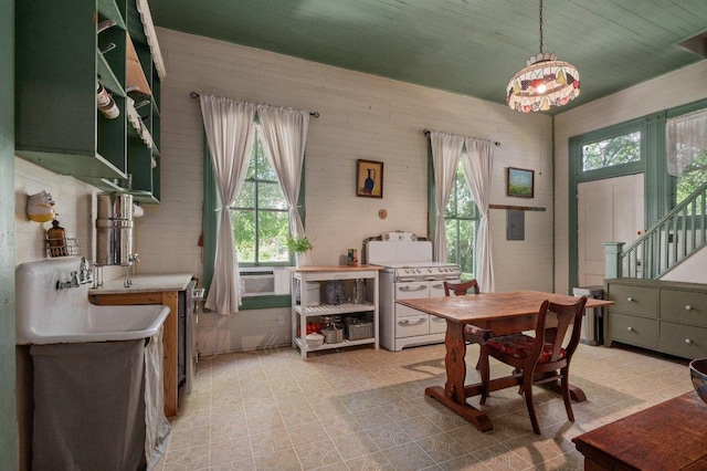 124 N Hamilton St, Gonzales, TX 78629 - dining room featuring light flooring, stairway, and a chandelier