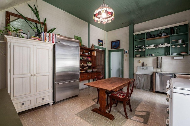 124 N Hamilton St, Gonzales, TX 78629 - kitchen featuring appliances with stainless steel finishes, pendant lighting, tile patterned floors, and open shelves