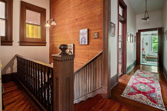 124 N Hamilton St, Gonzales, TX 78629 - hallway featuring wood finished floors and wooden walls