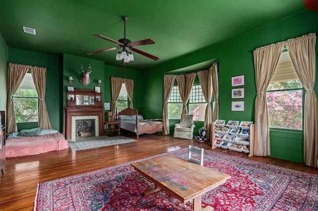 124 N Hamilton St, Gonzales, TX 78629 - living room featuring ceiling fan, wood finished floors, and a fireplace