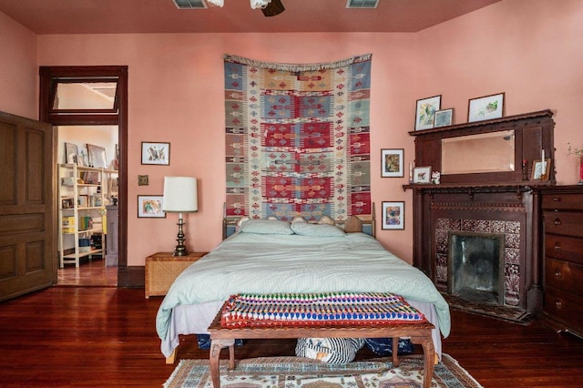 124 N Hamilton St, Gonzales, TX 78629 - bedroom with wood finished floors and a tile fireplace