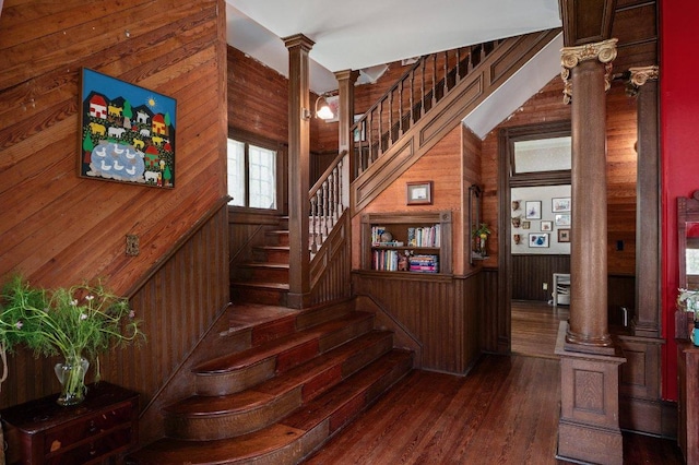 124 N Hamilton St, Gonzales, TX 78629 - stairway with decorative columns, wood walls, and wood finished floors