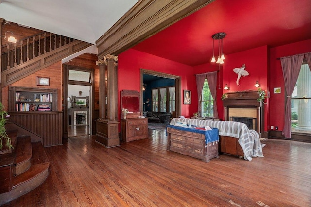 124 N Hamilton St, Gonzales, TX 78629 - living room with a fireplace, healthy amount of natural light, wood finished floors, and decorative columns
