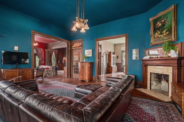 124 N Hamilton St, Gonzales, TX 78629 - living room with a fireplace, a chandelier, and wood finished floors