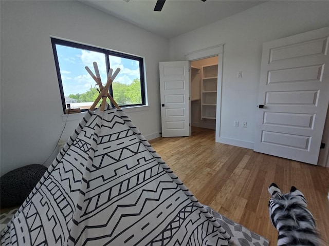 5301 Grover Ave, Austin, TX 78756 - bedroom with wood finished floors, a spacious closet, and ceiling fan