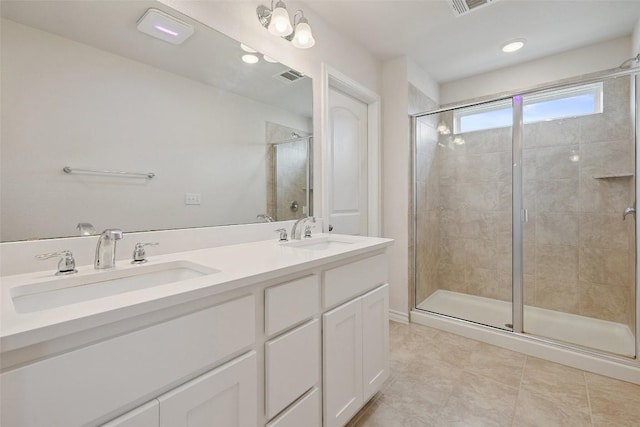 3003 Salvidar Bnd, Austin, TX 78728 - bathroom with a stall shower, double vanity, and tile patterned floors