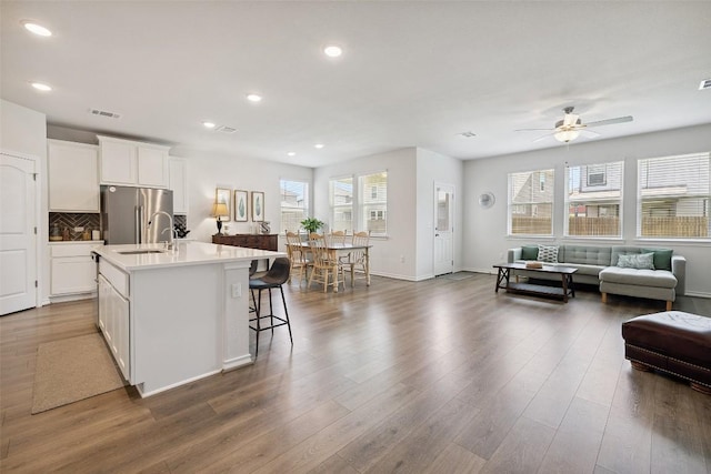 3003 Salvidar Bnd, Austin, TX 78728 - kitchen with freestanding refrigerator, open floor plan, healthy amount of natural light, ceiling fan, and recessed lighting