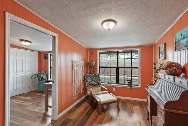 213 Circle C Ave, Fort Davis, TX 79734 - sitting room featuring ornamental molding, wood finished floors, a textured ceiling, and wooden walls