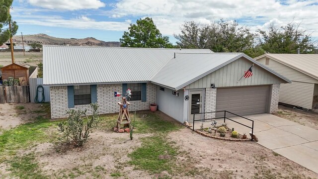 213 Circle C Ave, Fort Davis, TX 79734 - single story home featuring a garage, driveway, and a metal roof