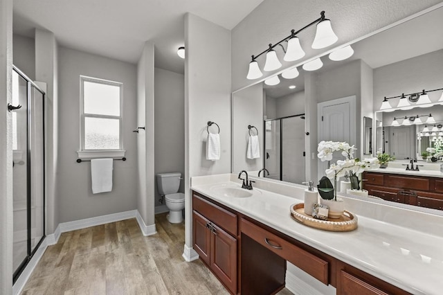 4024 Camacho St, Austin, TX 78723 - full bathroom with a stall shower, wood finished floors, and vanity